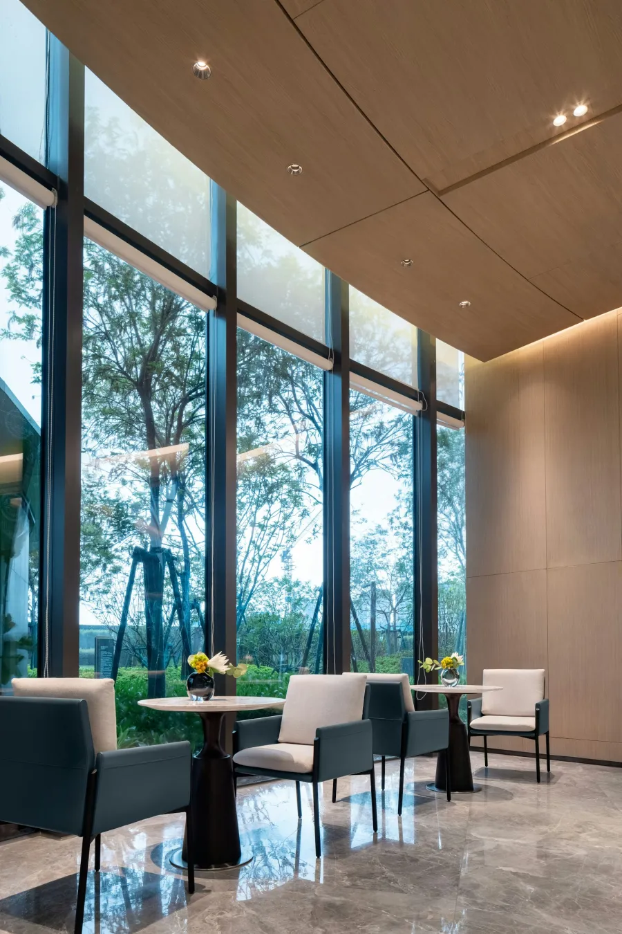 Sattva Songbird clubhouse lounge seating area with garden view