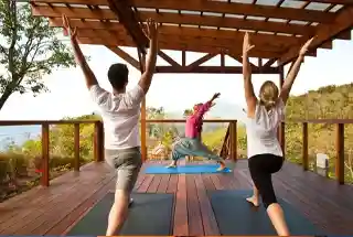 Representative image of residents on a timber yoga and meditation deck, as listed for Sobha Wisteria Egattur