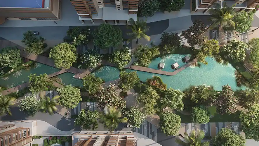 Top-down view of the Sattva City lagoon pool with deck walkways and cabanas among towers